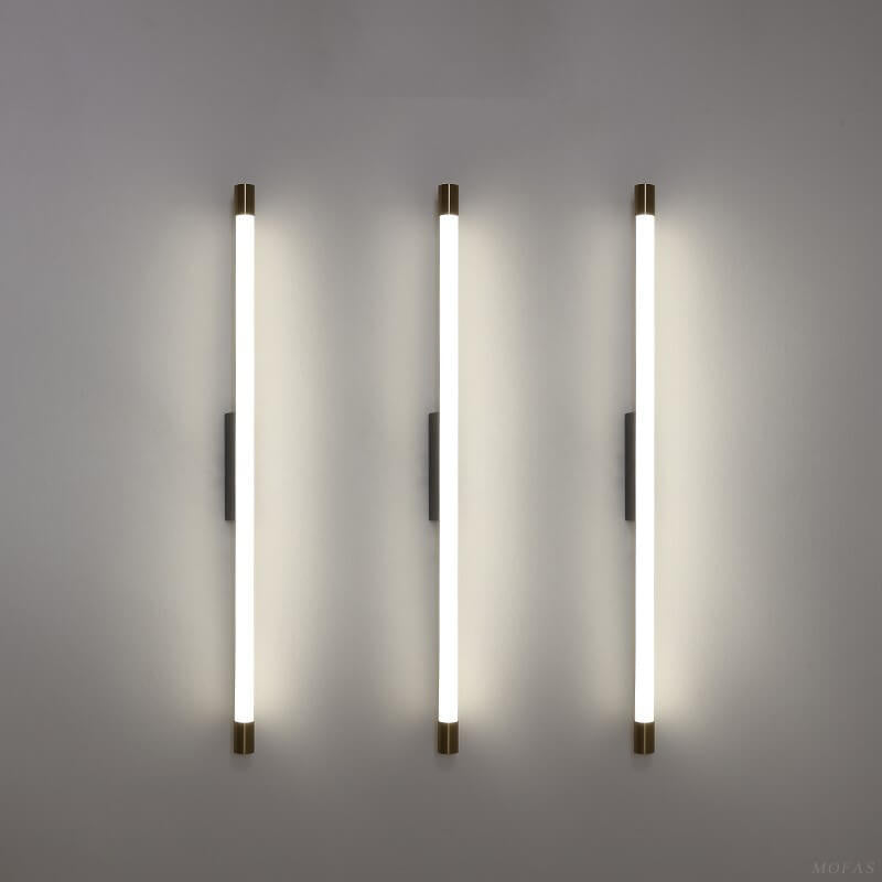 Close view of the brass end cap on the aluminum LED tube sconce
