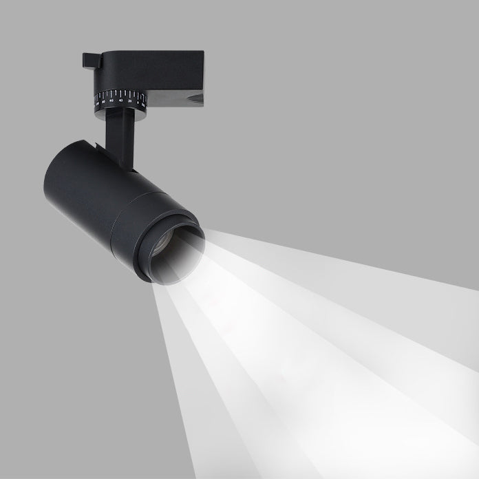 Black tubular spotlight head with graduated tilt dial casting a beam