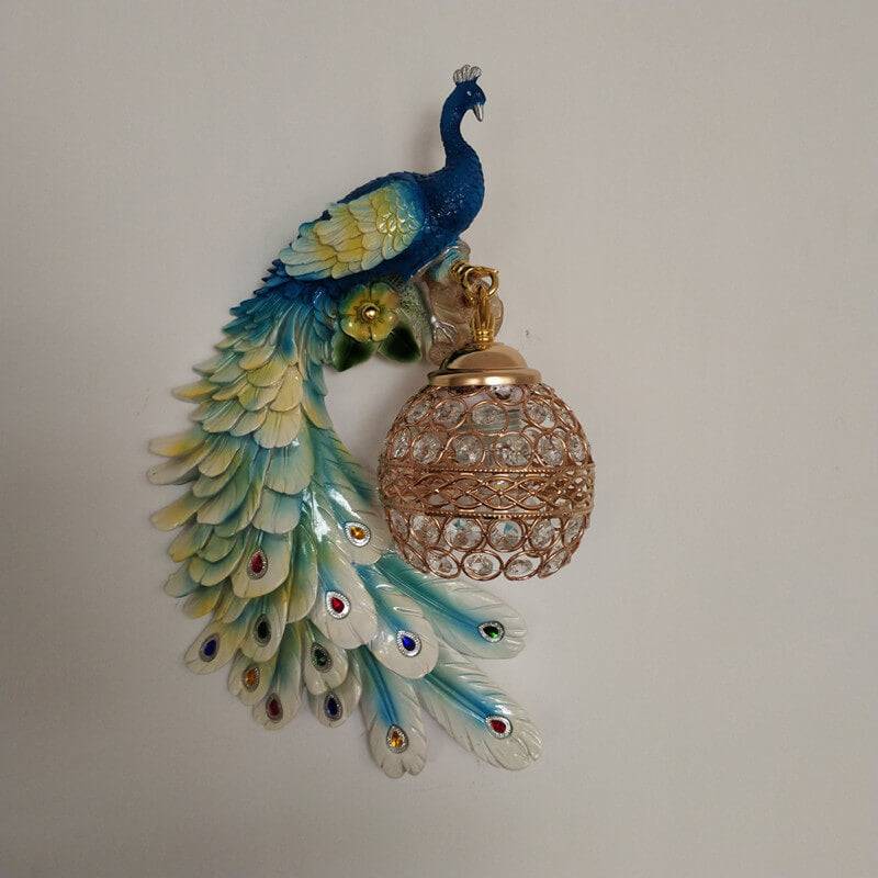 Blue and yellow peacock wall sconce with fanned tail feathers in front view