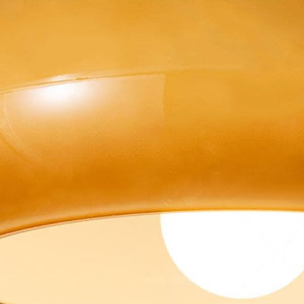Amber glass flush mount light with glowing open bottom diffuser