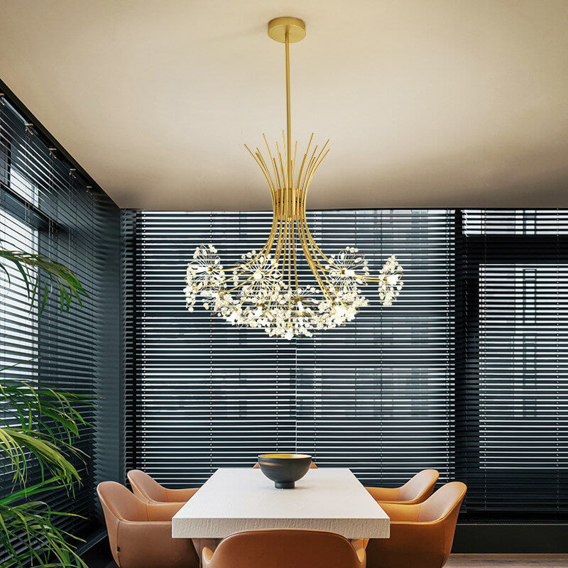 Gold dandelion chandelier over a dining table beside slatted window blinds