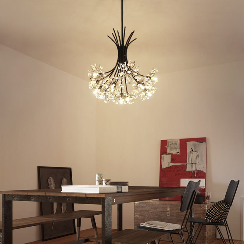 Black glass chandelier lighting a wooden dining table with red wall art