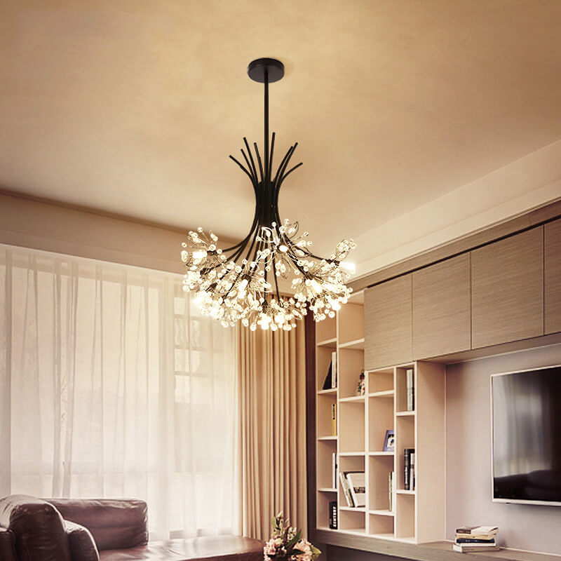Black glass chandelier in a living room above shelving and a television