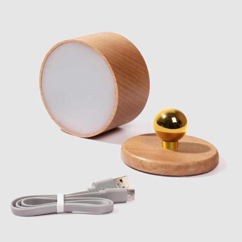 Beech wall sconce casting a soft warm pool of light on a wall