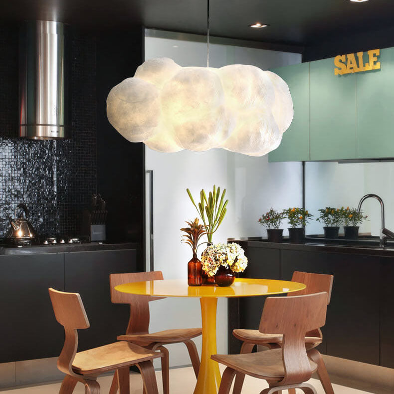 White cloud pendant hanging above a yellow kitchen dining table