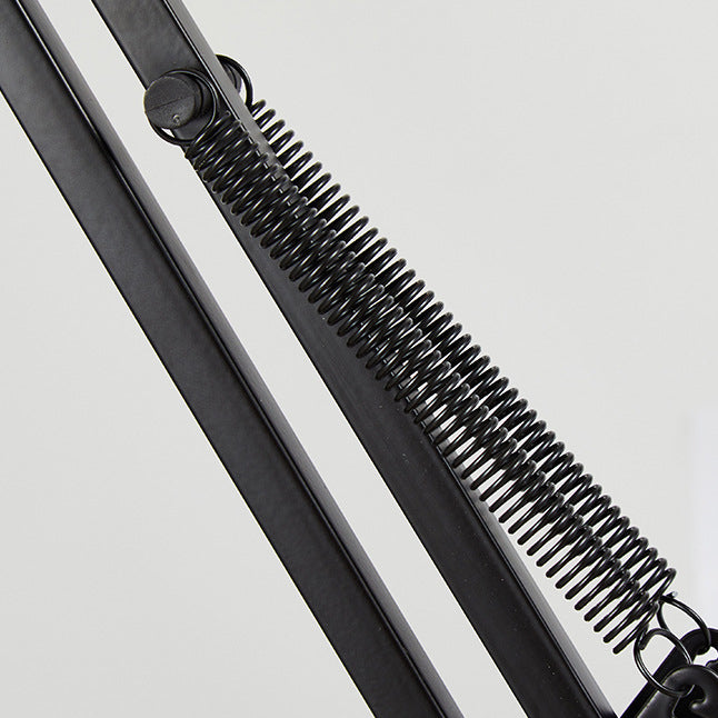 Clip-on desk lamp positioned low over a work surface