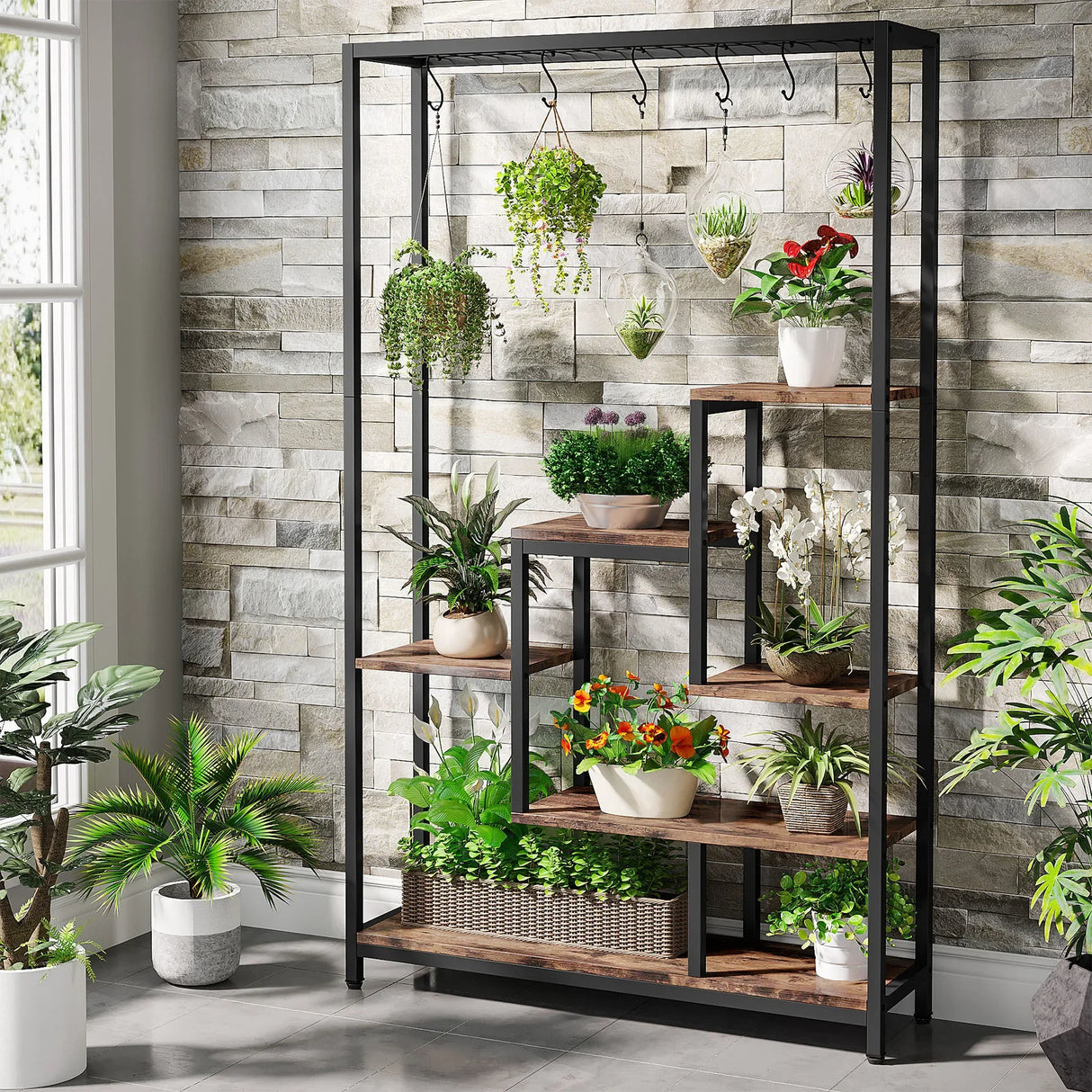 5 tier plant stand holding multiple indoor potted plants