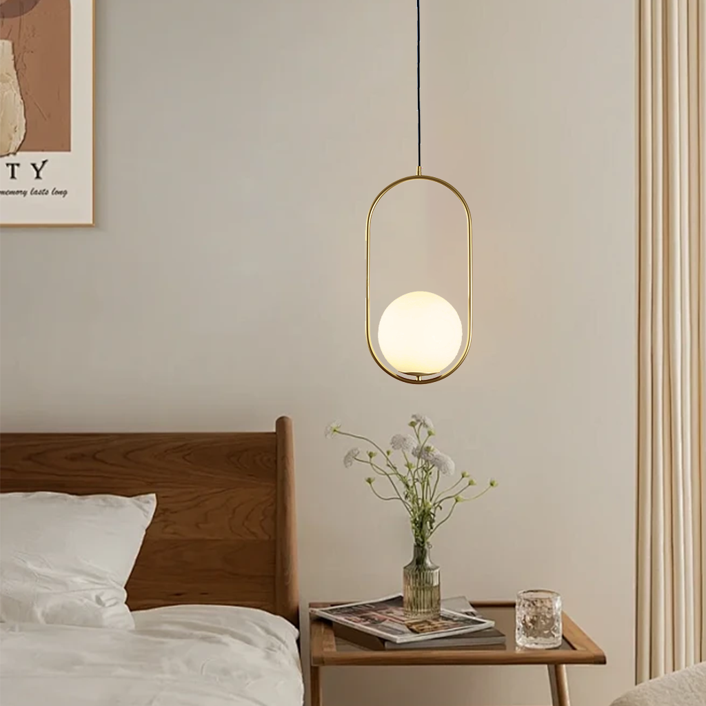 Black oval and round frame glass globe pendants above a wood coffee table