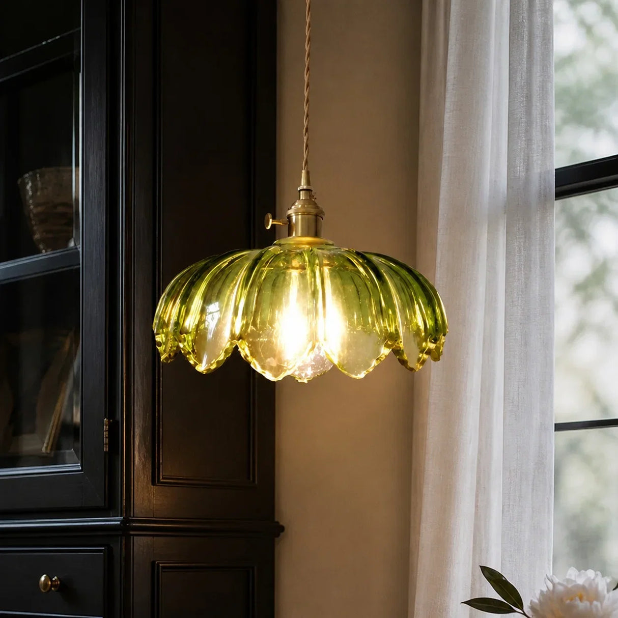 Tulip glass pendant light glowing warmly