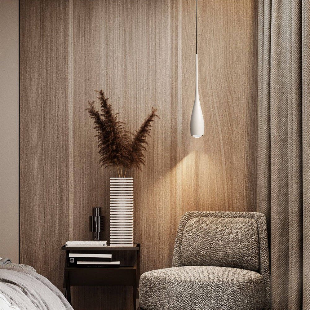 Water drop pendant light glowing in a minimalist living room