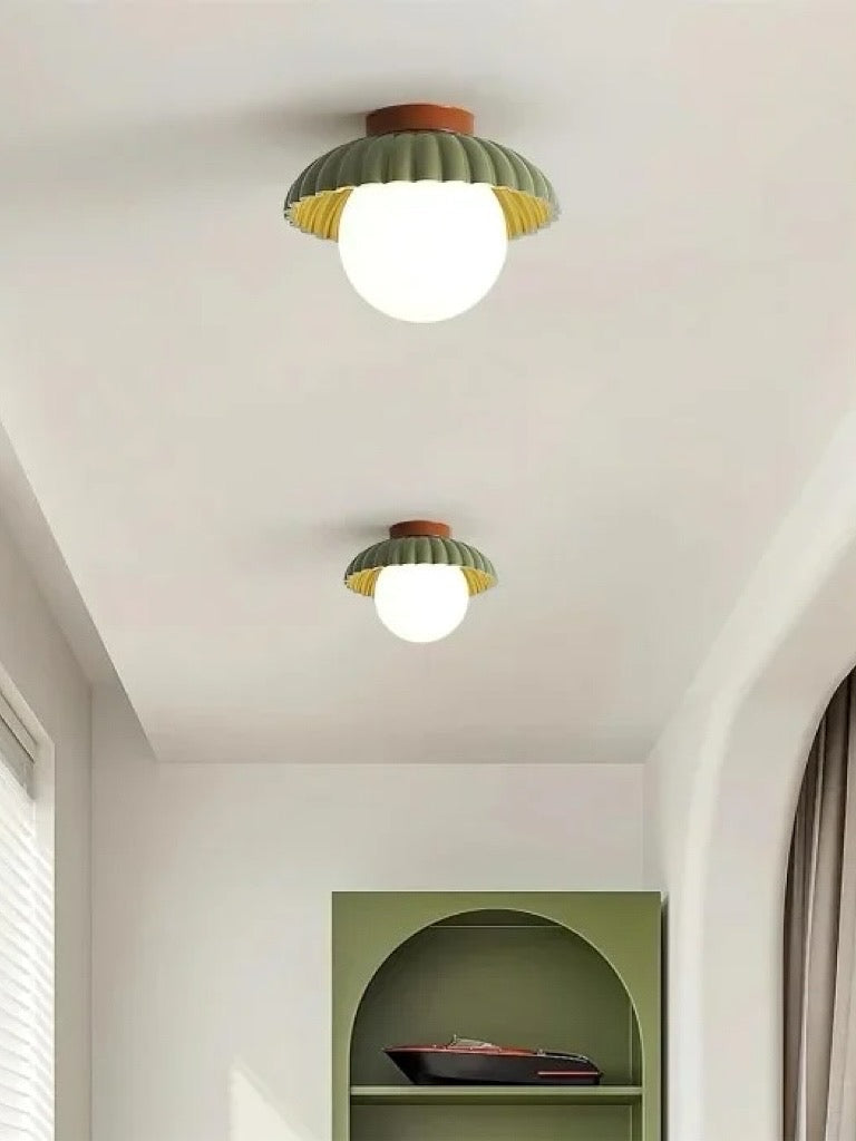 Modern glass flush mount ceiling light seen from below when lit