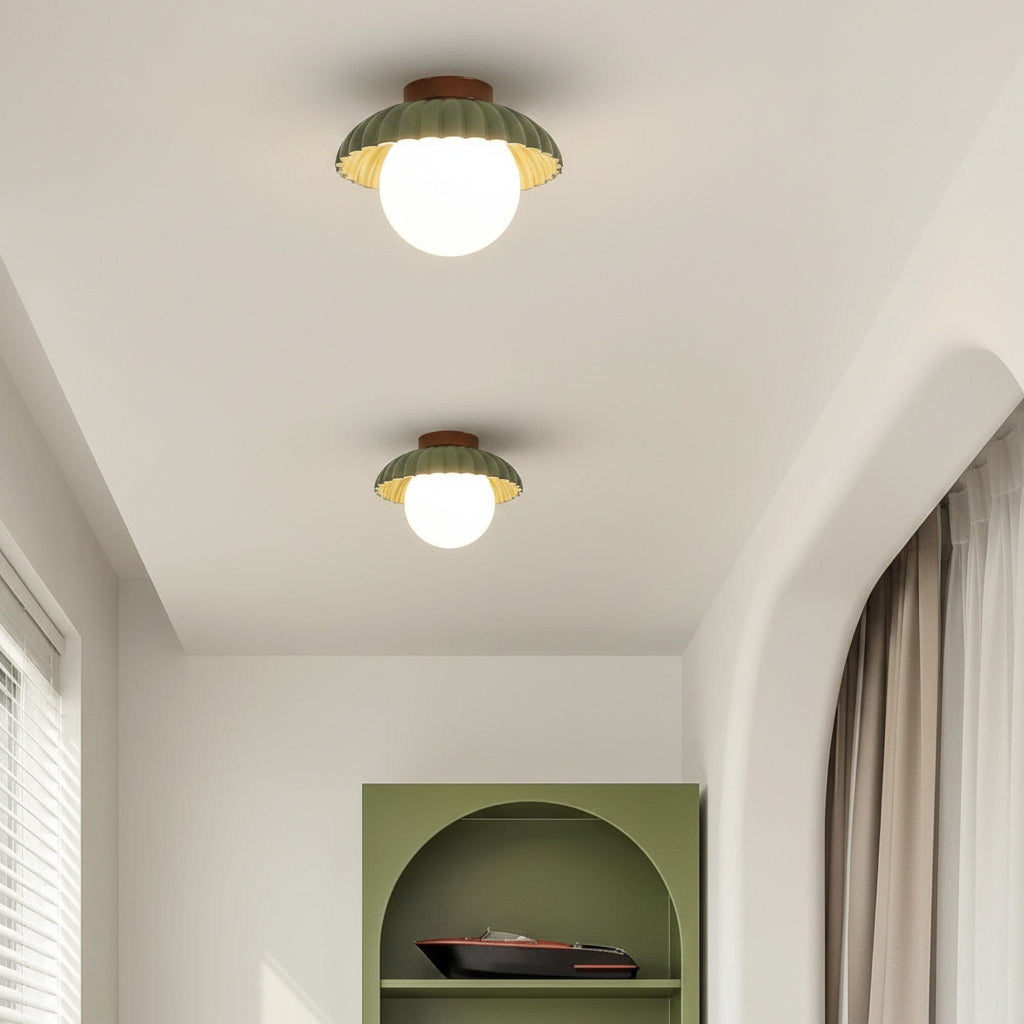 Modern glass flush mount ceiling light seen from below when lit
