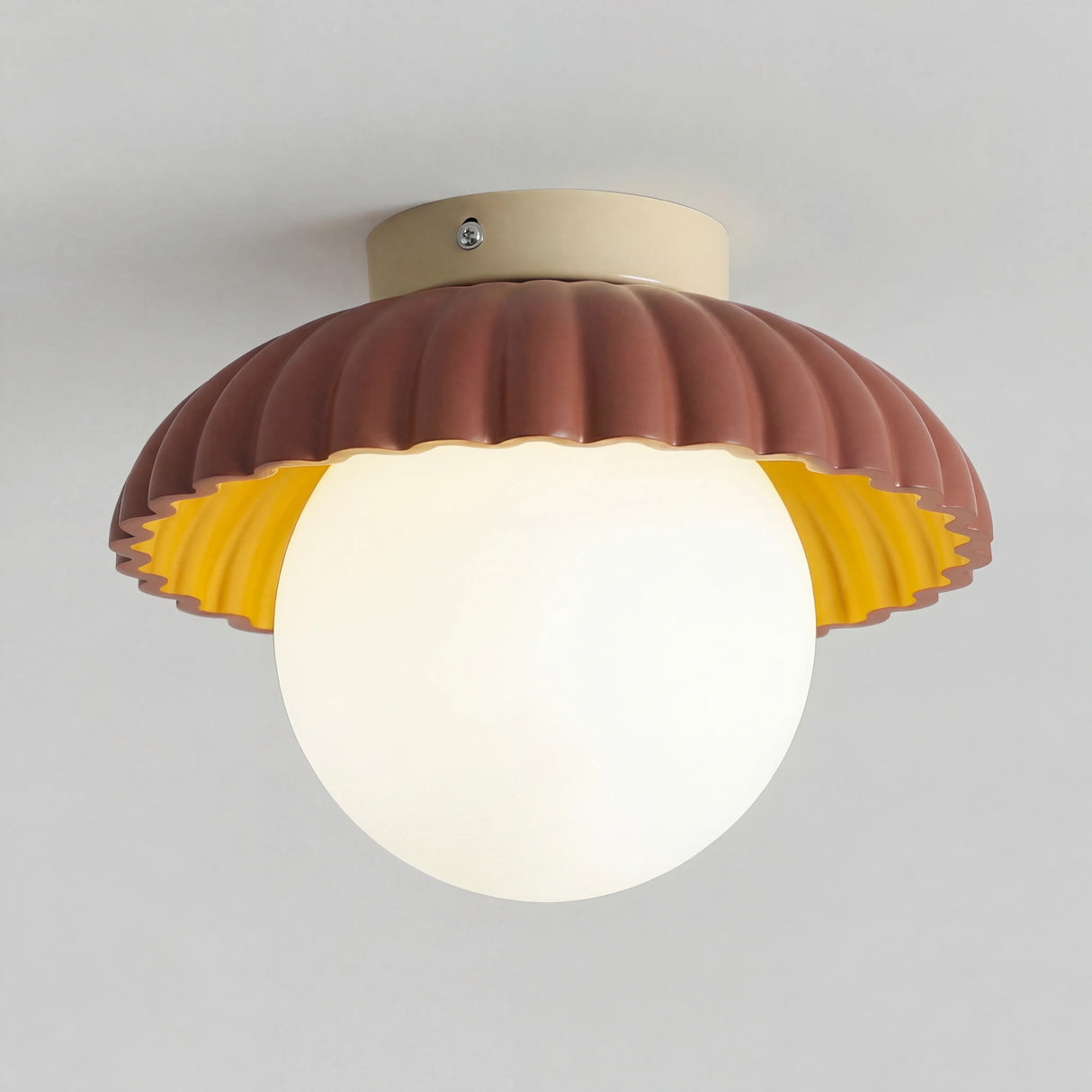 Cream petal flush mount ceiling light with opal glass globe on a white background