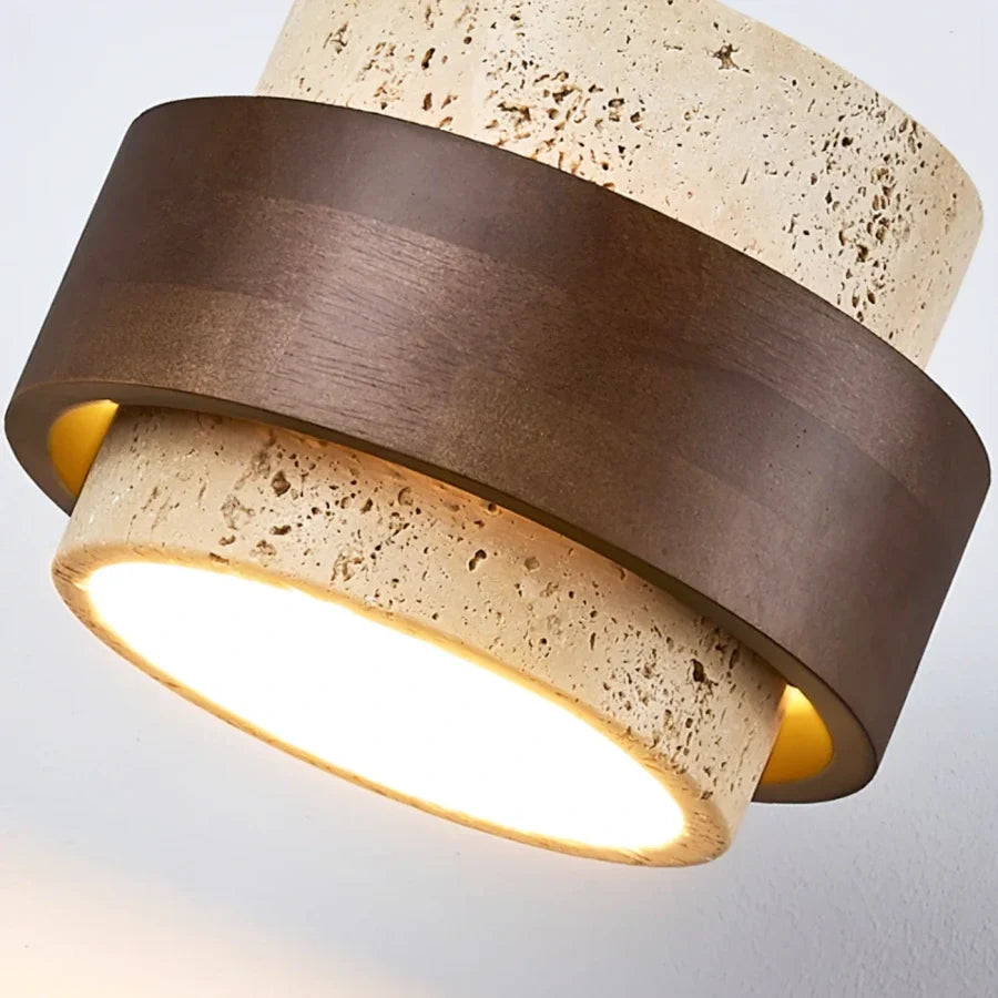 Travertine flush mount light with walnut collar shown at eye level