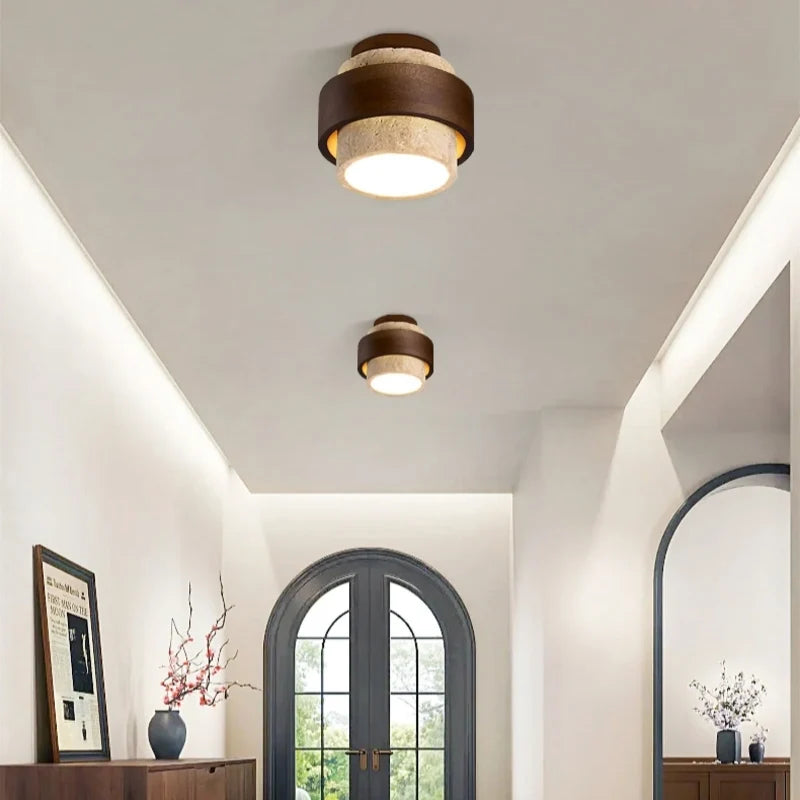 Yellow travertine ceiling light with dark walnut banding in soft light
