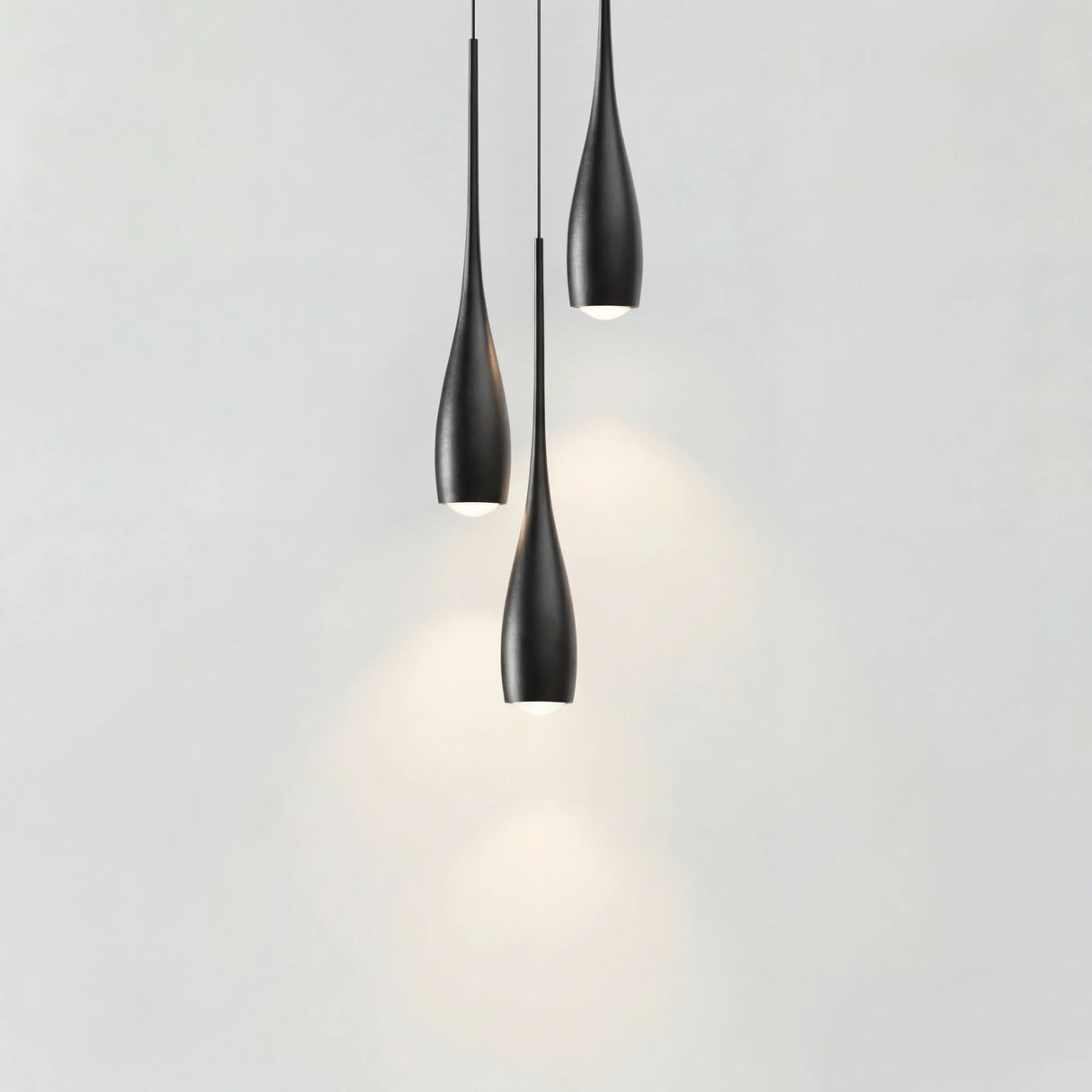Water drop pendant light with slim teardrop aluminium shade on white background