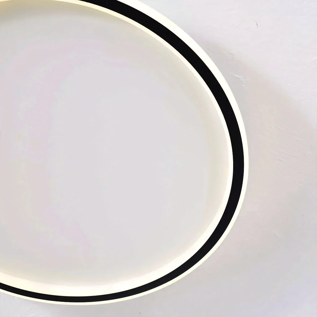 Detail of the slim metal ring frame on the round ceiling light