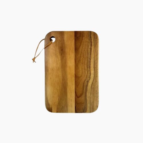 Large acacia cutting board with handle on kitchen counter