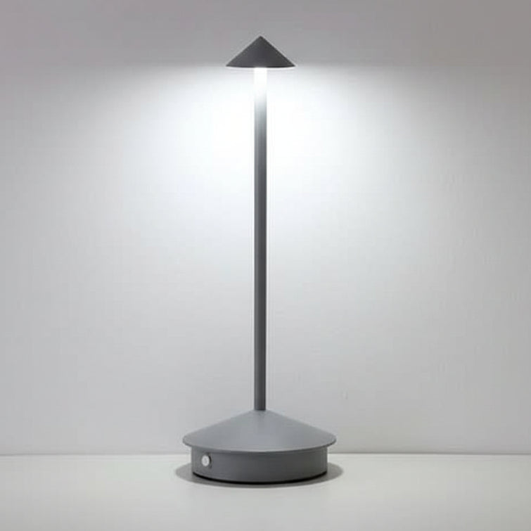 Cordless dimmable table lamp lit softly on a wooden tabletop indoors