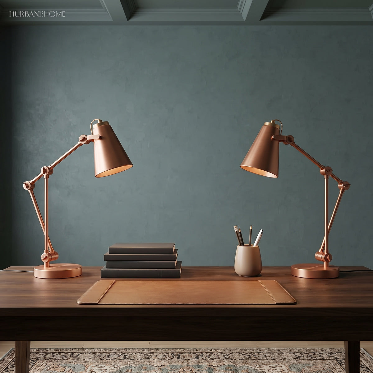 Two copper toned adjustable desk lamps on a dark wood writing table