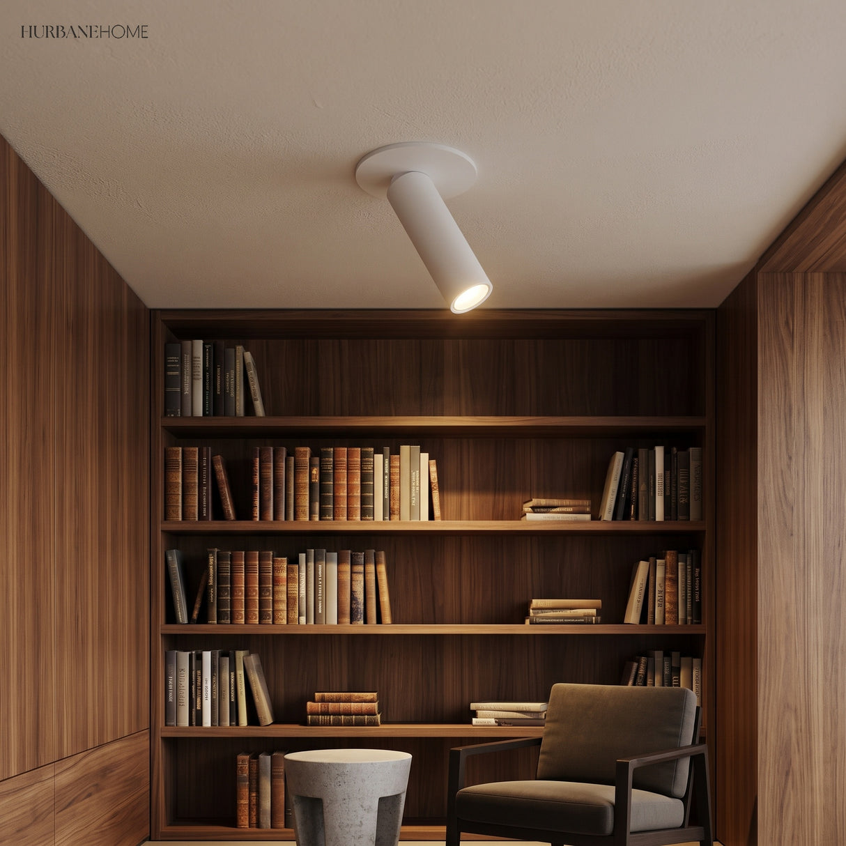 White tube spotlight lighting a walnut lined library with armchair and books