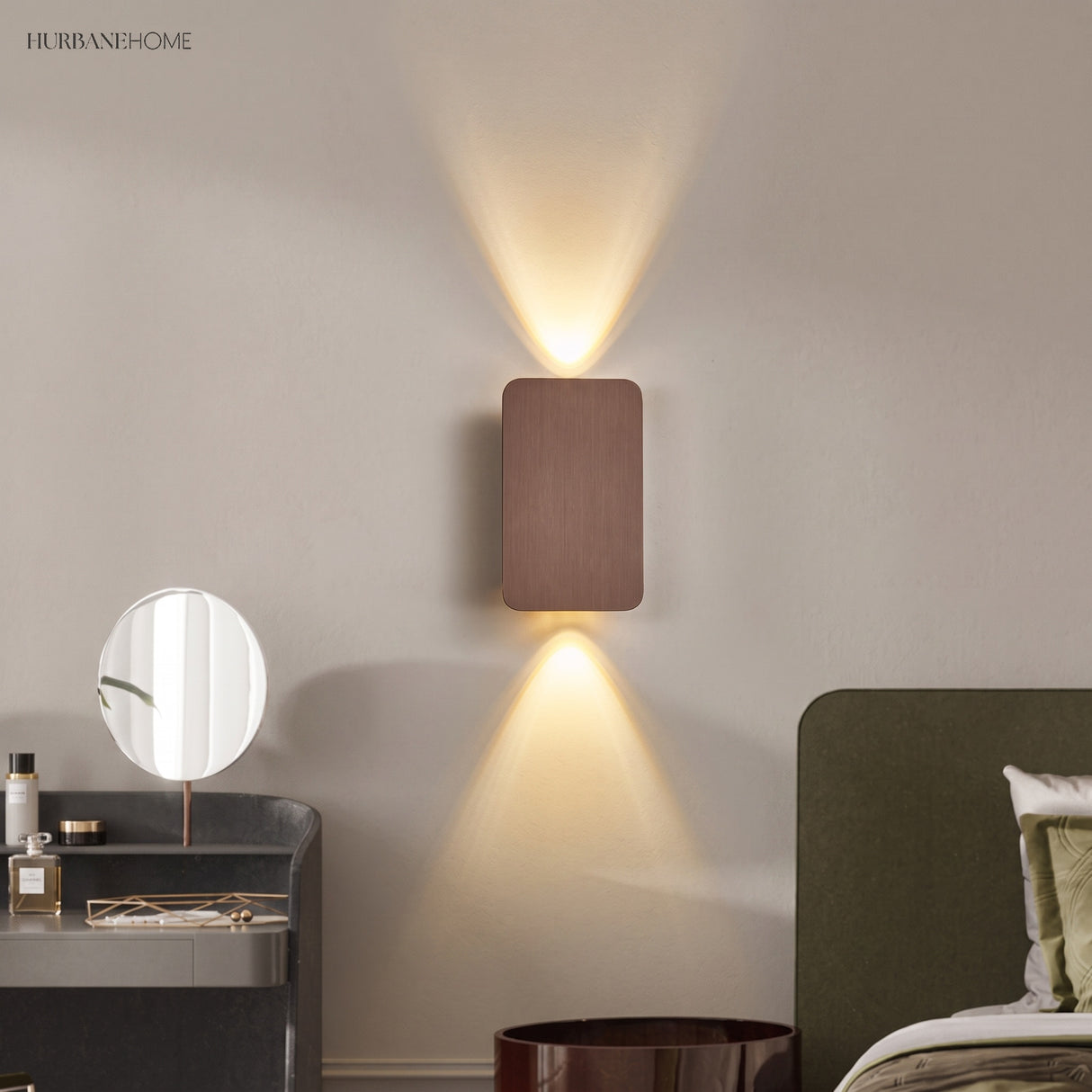 Coffee up and down wall sconce beside a bed and round vanity mirror