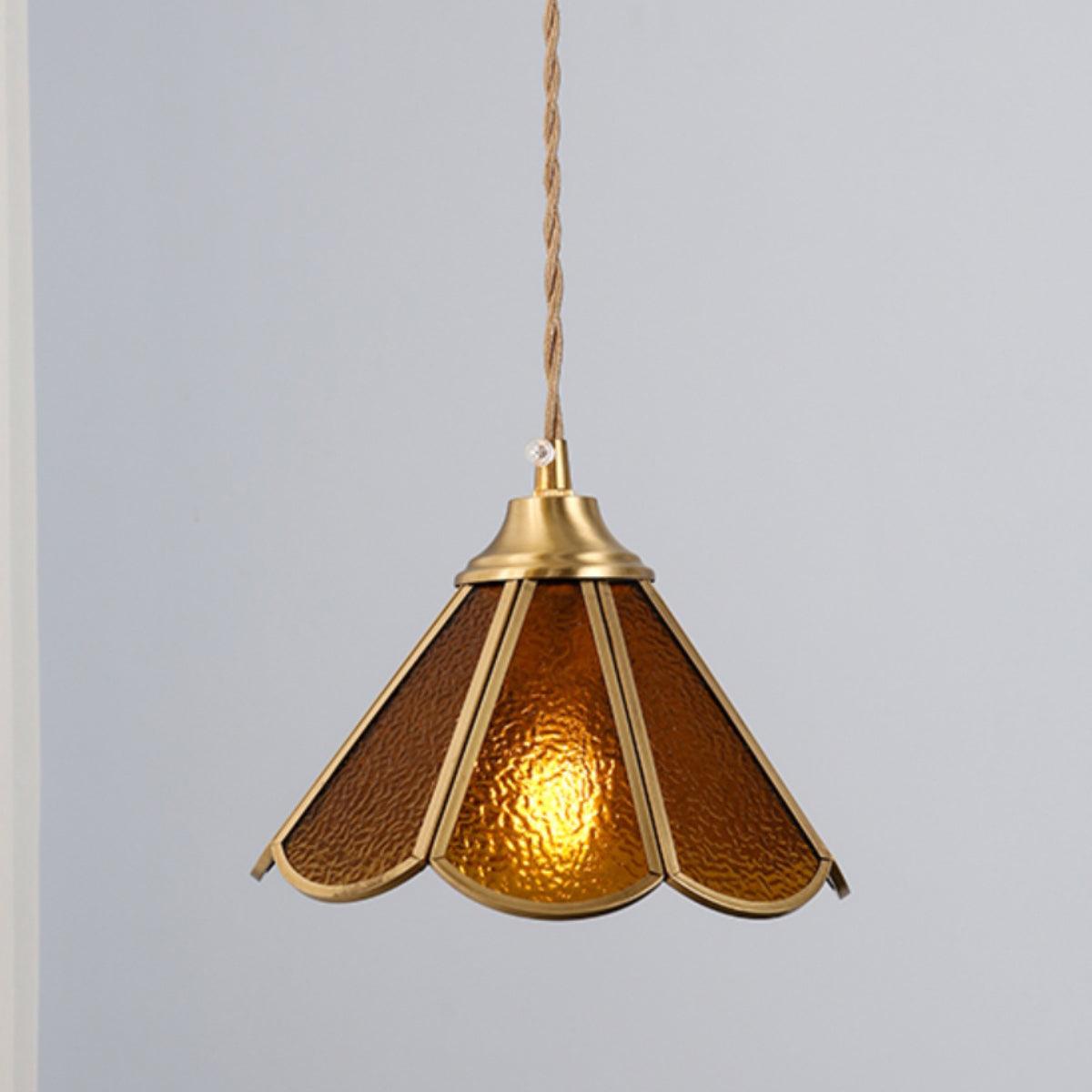 Amber glass pendant shown alone with the textured panels lit from inside