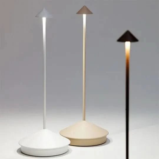 Waterproof cordless table lamp standing on an outdoor garden table