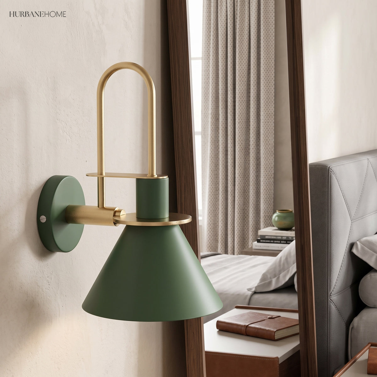 Green cone wall sconce beside a bedroom mirror and made bed
