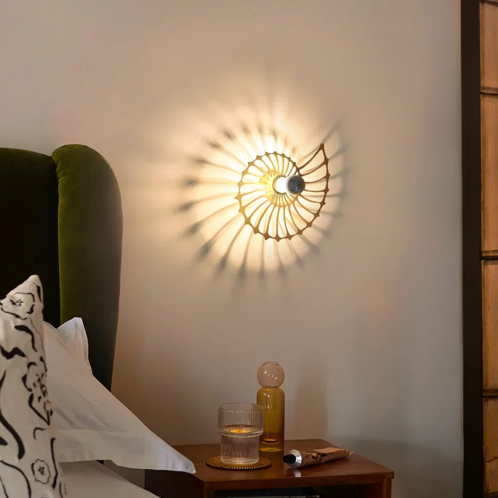 Shell wall light above a bedroom bed