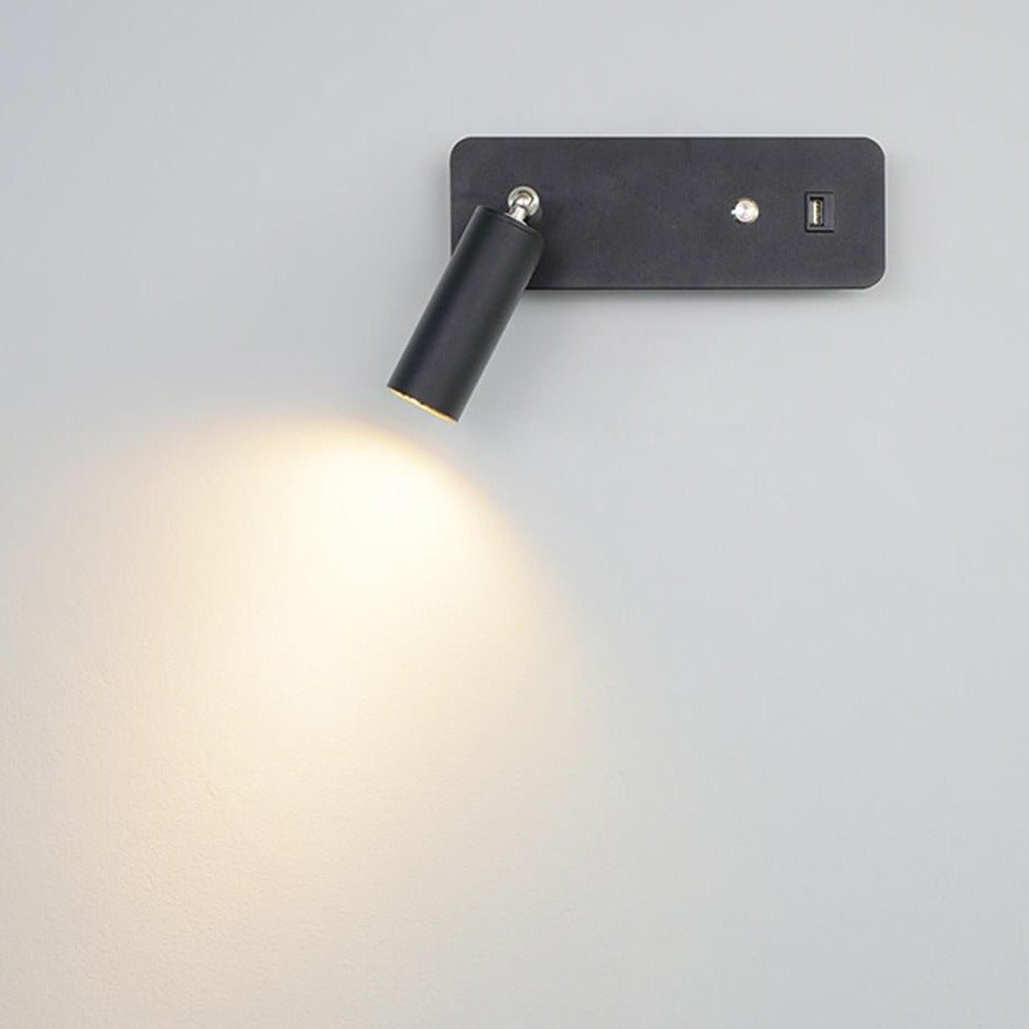 Close view of the black reading light head aimed down at the wall