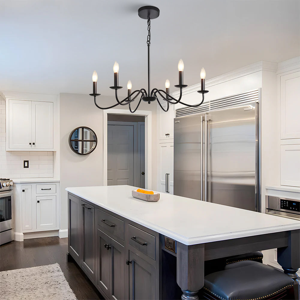 Six light black candle chandelier above a grey kitchen island in a white kitchen