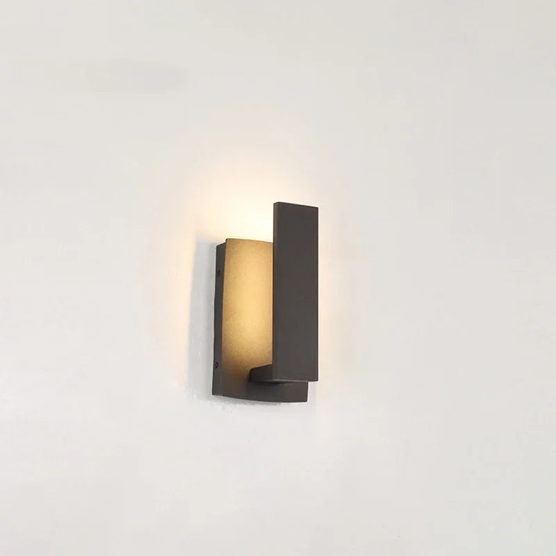 Black LED wall sconce mounted outdoors on exterior wall