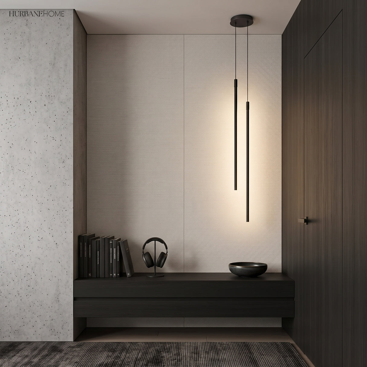 Two black tube pendant lights lighting a dark minimalist entryway bench