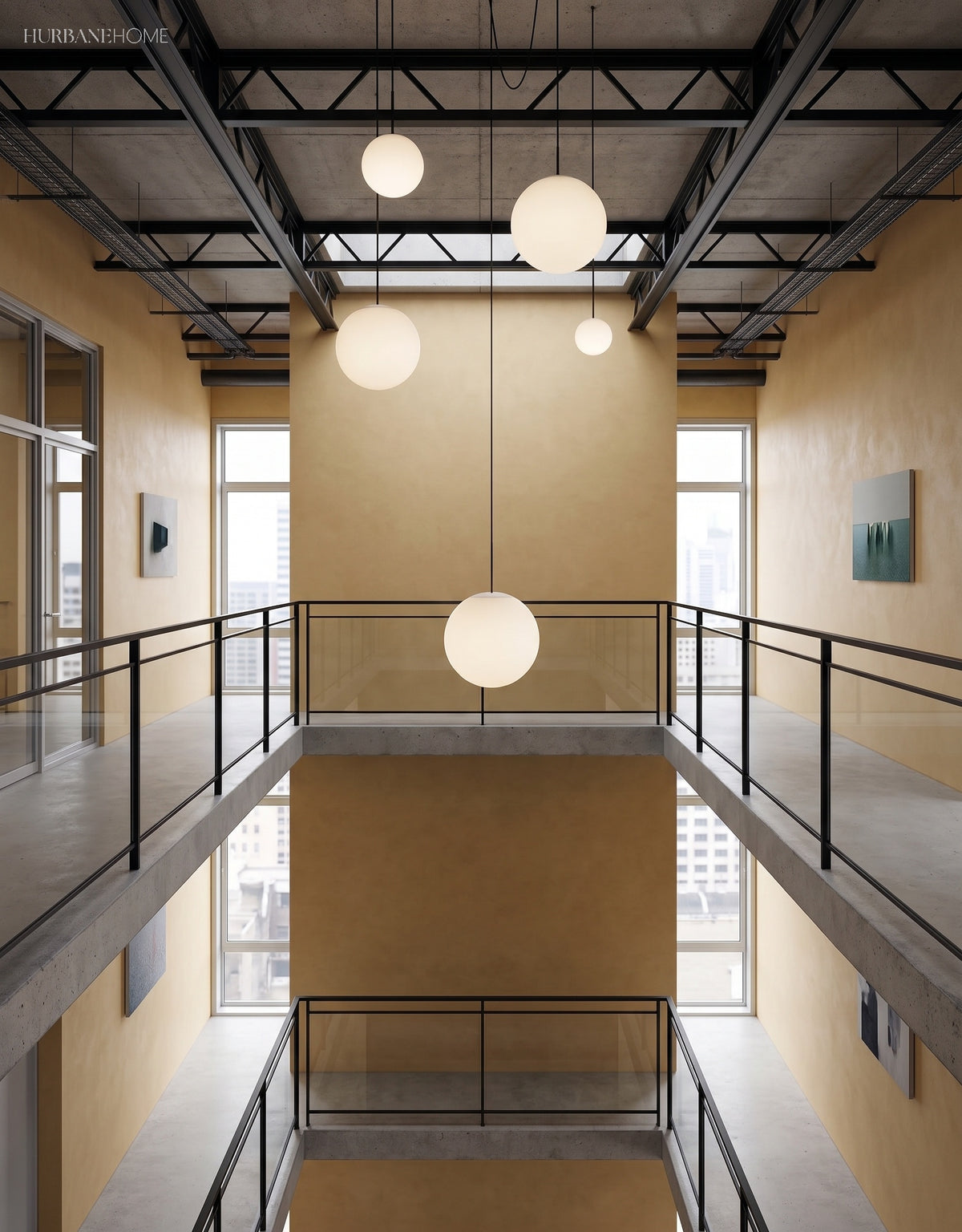 Brass stem globe pendants at varied heights in a double height atrium