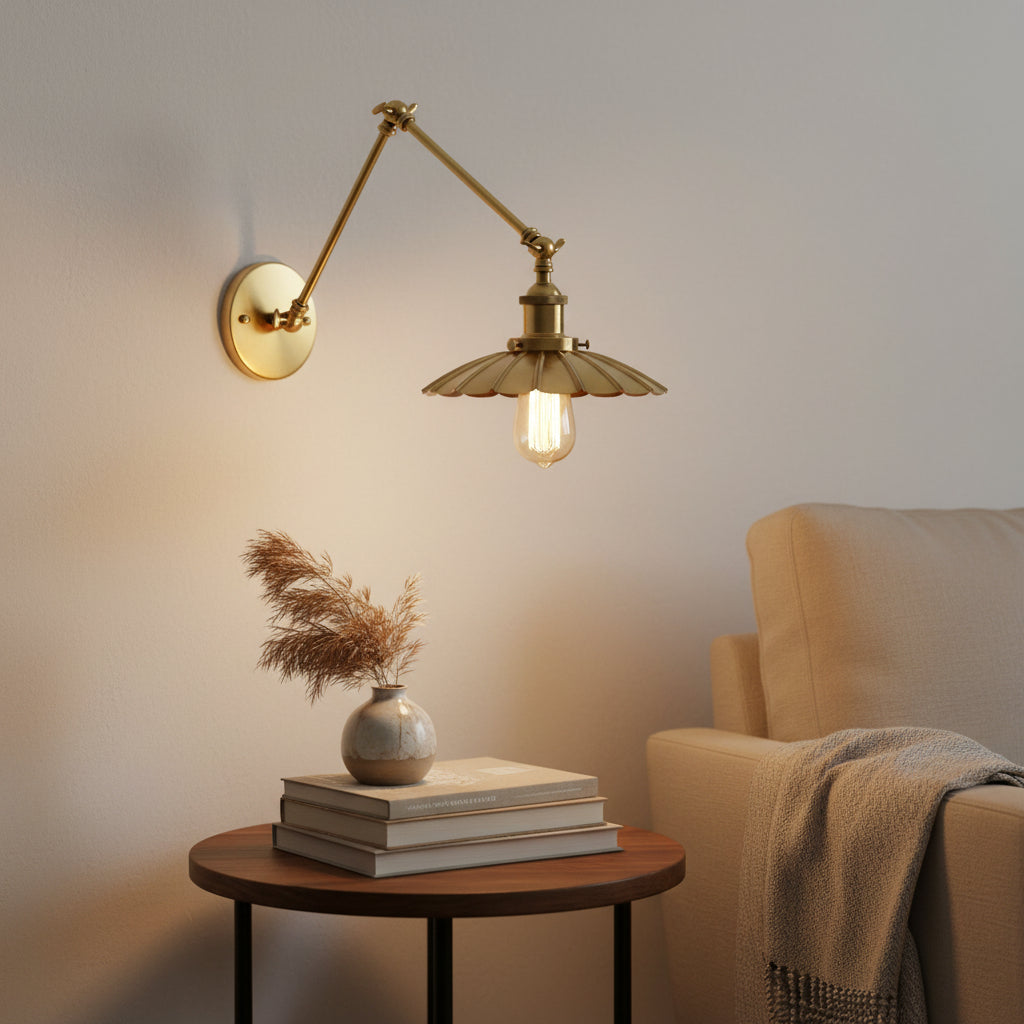 Brass sconce with a scalloped shade lit from below on white