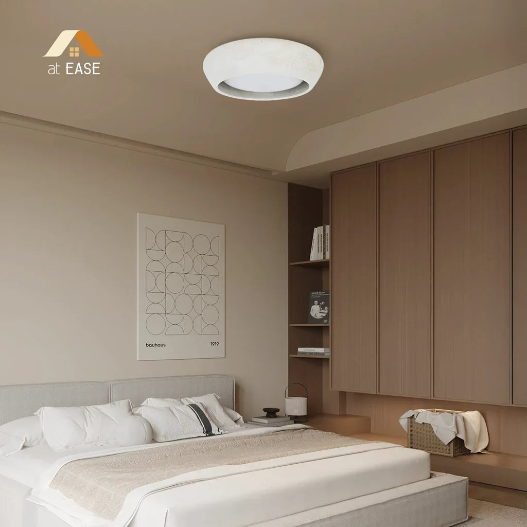 The low profile ceiling light shown installed above a minimalist seating area