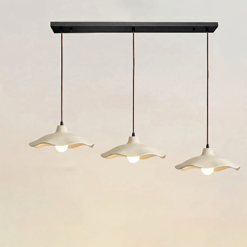 Three-light linear cement pendant fixture on one black ceiling plate