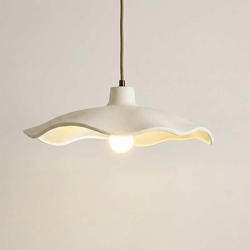 Underside of the off-white cement petal shade around an exposed bulb