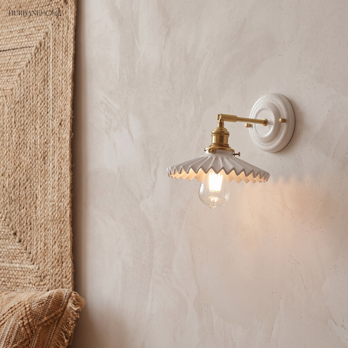 Ceramic and brass wall sconce in a styled interior
