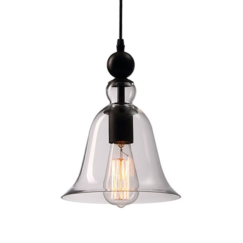Clear glass bell pendant and black fitting on a plain background