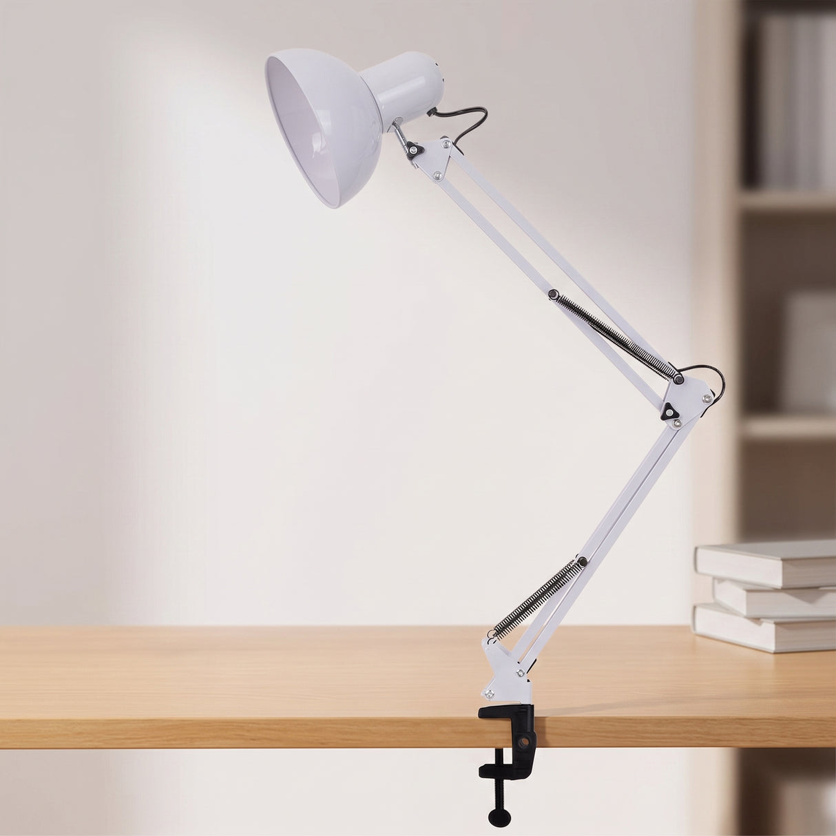 Retractable swing arm clip-on desk lamp, studio product photo