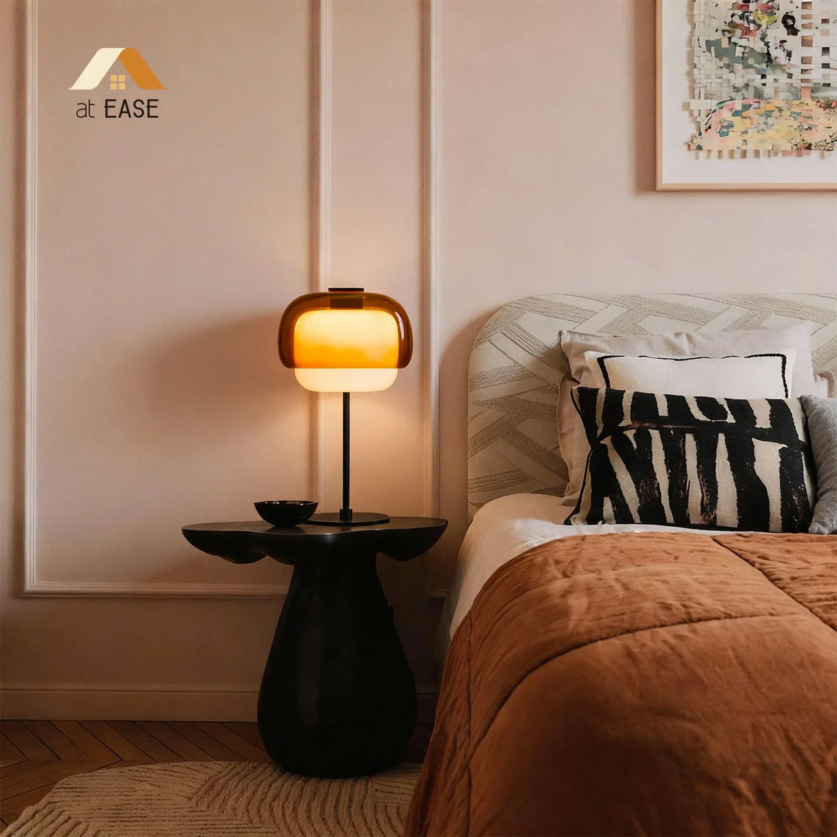 Angled pink glass table lamp showing the rounded shade and metal stem