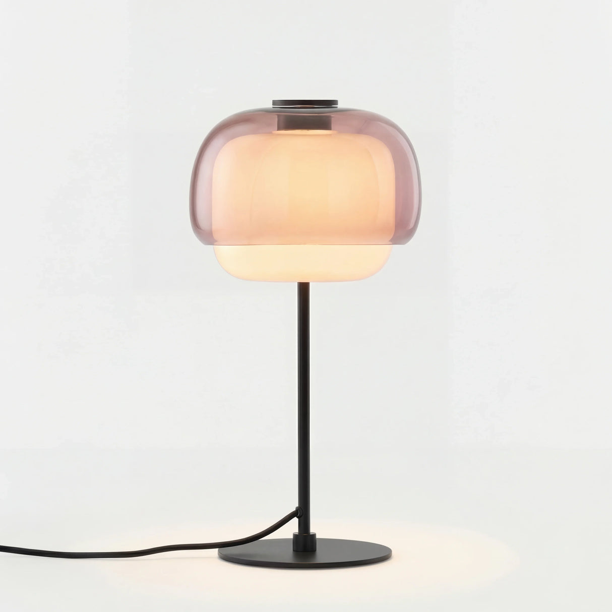 Colored glass domed table lamp shown against a plain studio background