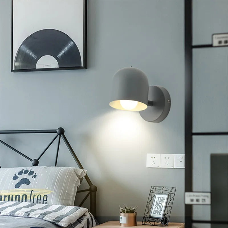 Green macaron sconce throwing a soft pool of light down a plain wall