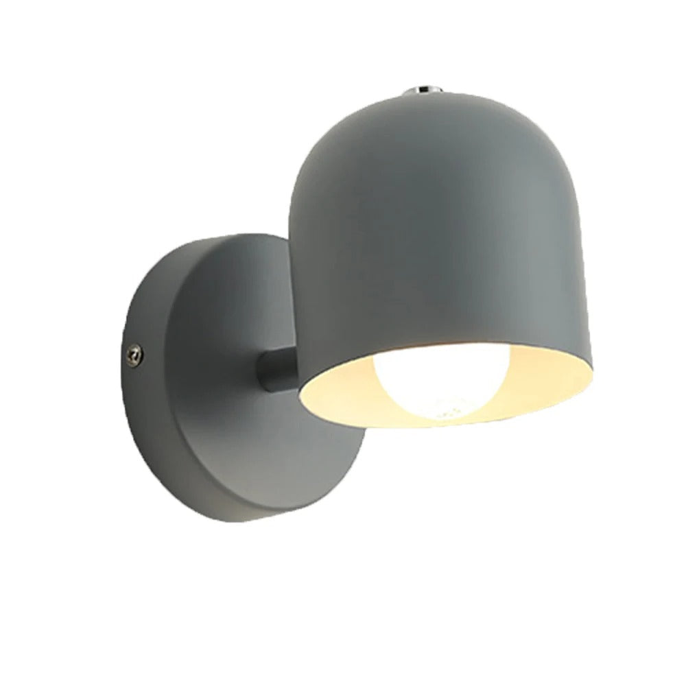 Macaron dome sconce turned to show the tilting stem joint
