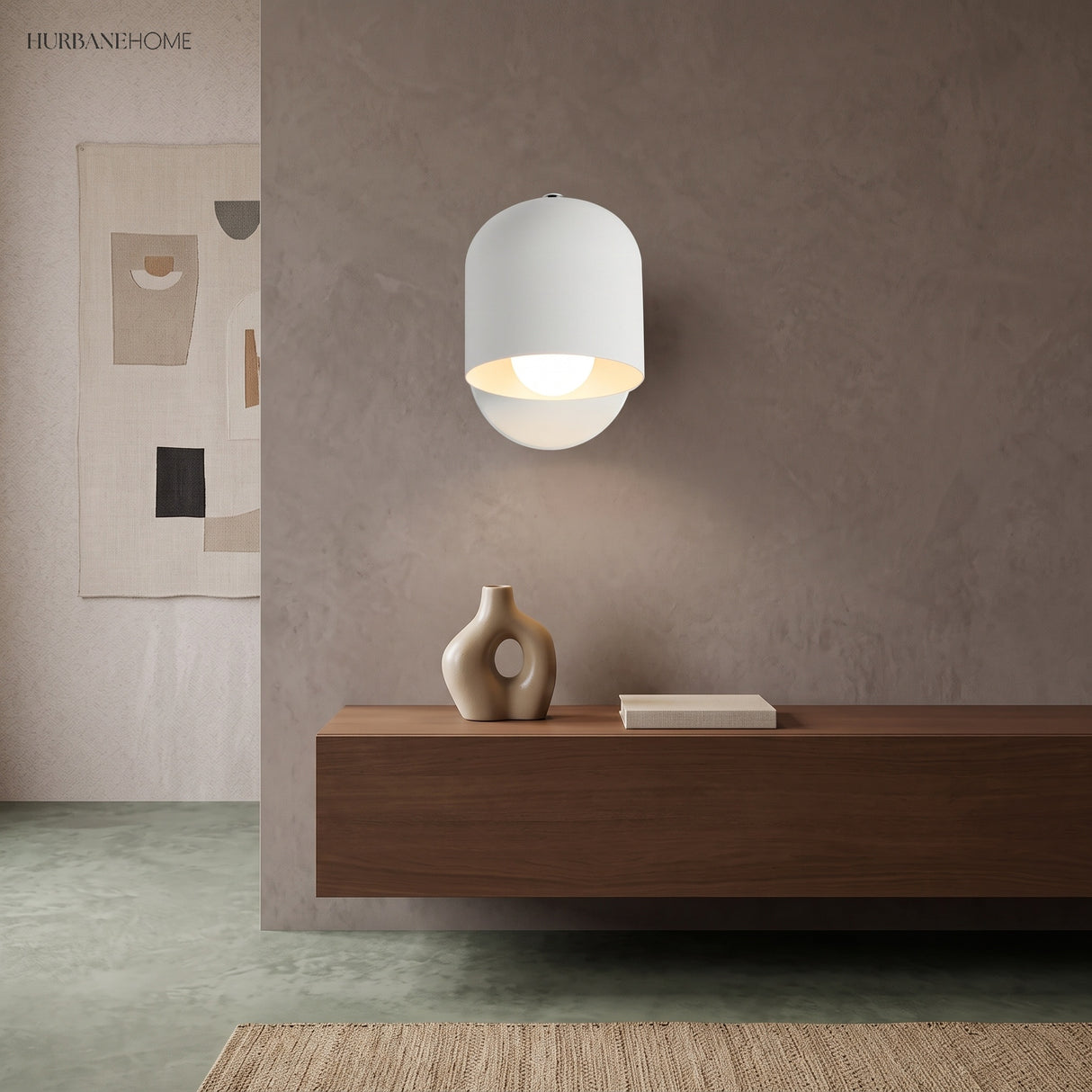 White dome wall sconce lit over a walnut console and vases