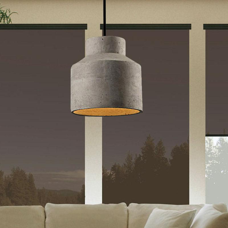 Cylinder cement pendant hanging by a window with a forest view