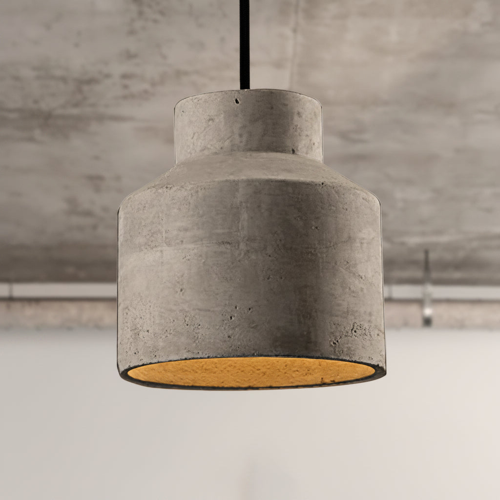 Two stepped cylinder cement pendants lit against a concrete wall