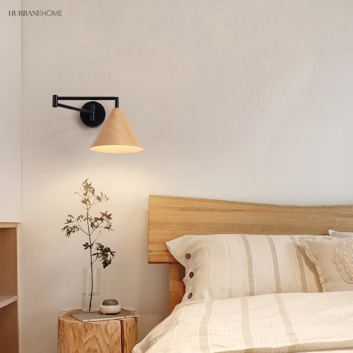 Cone shade swing arm wall sconce in a styled bedroom